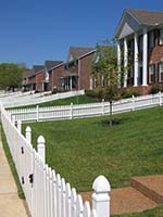 Tract Home Neighborhood with Turf Grass Lawns and White Picket Fences