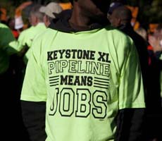 Green T-shirt that says Keystone XL Pipeline Means Jobs - Photo: Dallas News