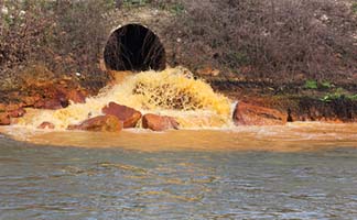 Pipe Dumping Pollution into River