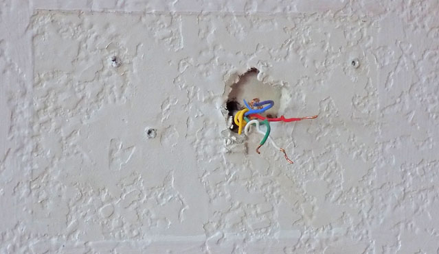 Wall After Removal of Thermostat with Wires Sticking Out.