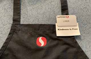 My Safeway apron with a "kindness is free" card and name tag.